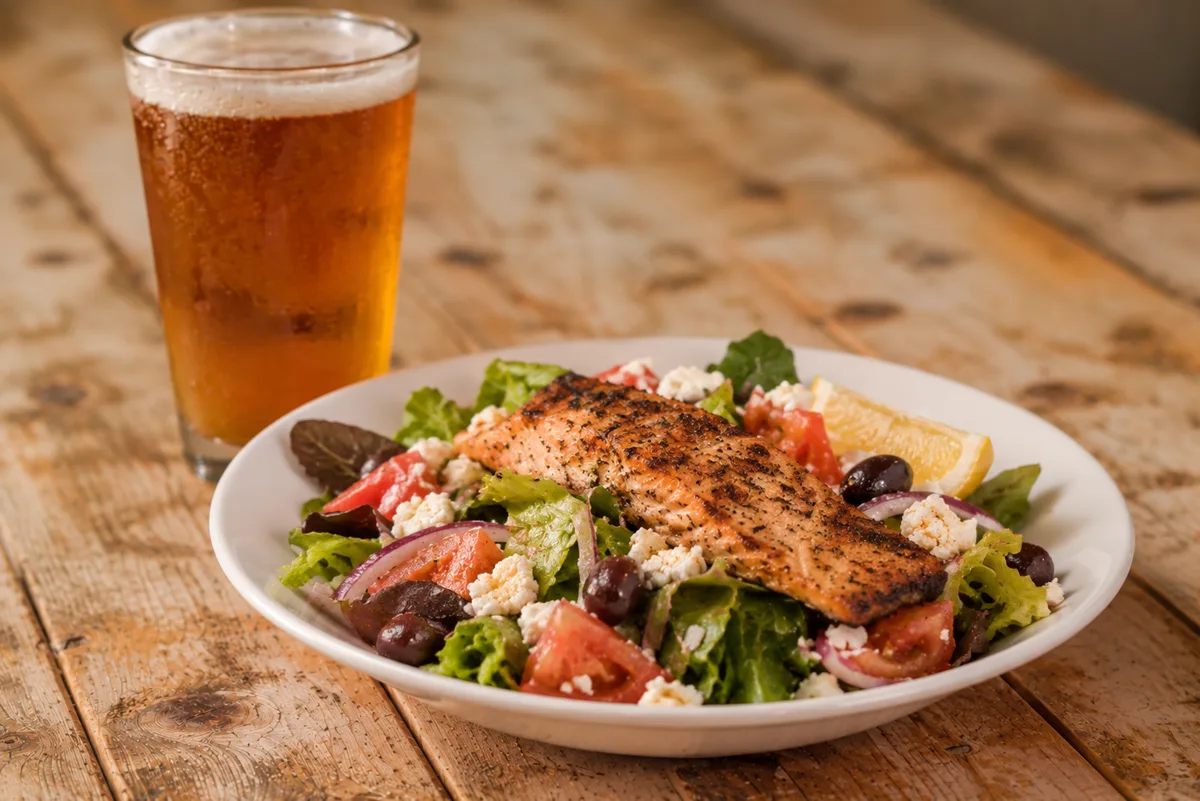 Grilled salmon salad with greens, feta and olives